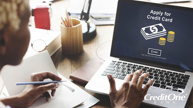 A woman uses a laptop to apply for a credit card, even though she may have no or bad credit history.